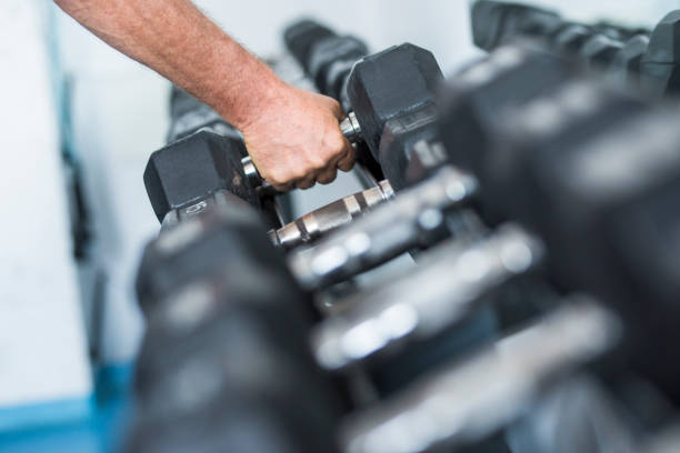 istock one teenager at the gym alone working is body and training doing elevations - black and white picture - strong man and helathy lifestyle 1293506077