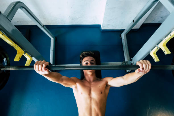 istock one teenager at the gym alone working is body and training doing elevations - black and white picture - strong man and helathy lifestyle 1293506630