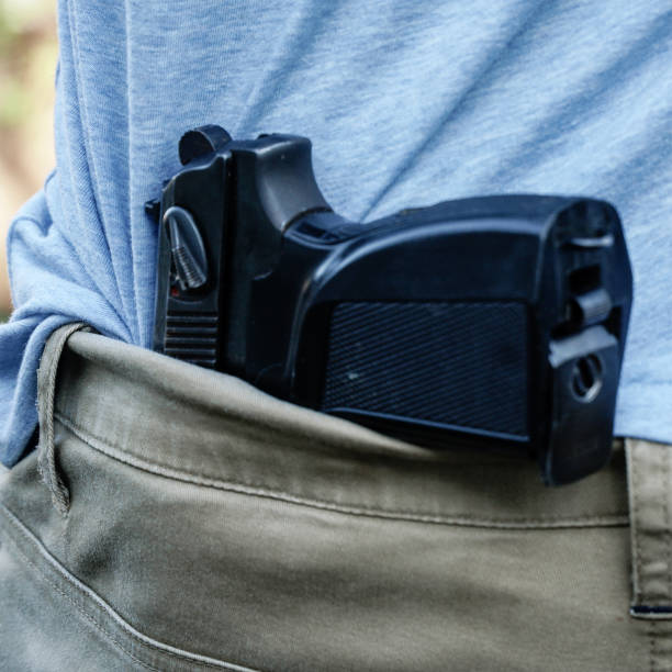 istock The gun is hidden behind man's back 1293508842