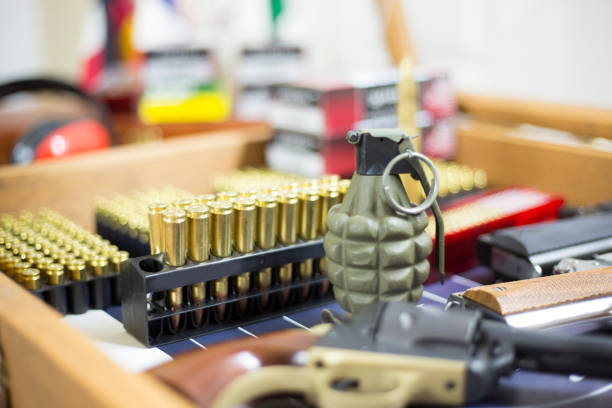 Ammunition, guns, and ear muffs in display case for sale.