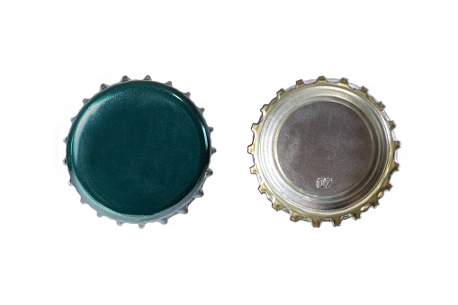 Both sides of a green metal bottle cap. One of the top side and one of the bottom side. Isolated on white background.