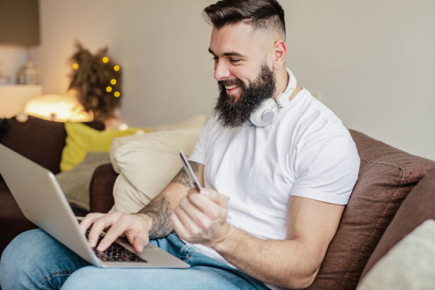 istock Man is using credit card for online shopping at home 1293513605