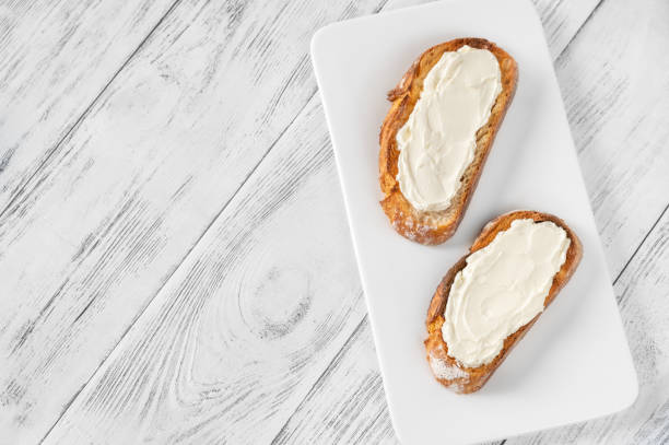 Toasts with cream cheese Toasts with cream cheese on the serving plate cream cheese photos stock pictures, royalty-free photos & images