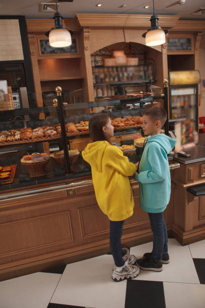 istock Lovely twins shopping at bakery 1293516373