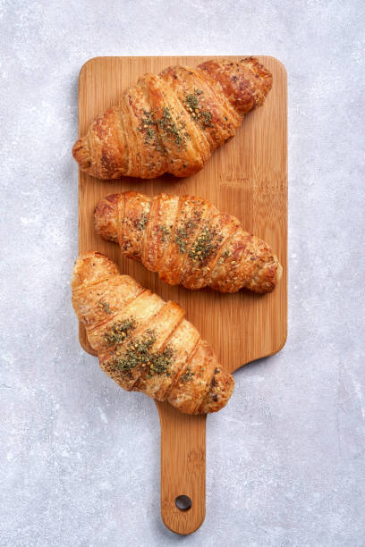istock Croissants on wooden board . Top view, vertical 1293518308