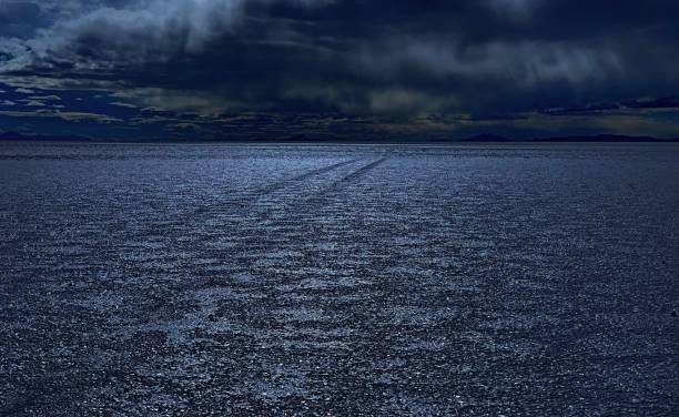istock Mystical twilight dusk over salt desert, silver sparkles on the earth ground, shiny night, glittering dirt, dark blue heaven, road to eternity. 1293520730