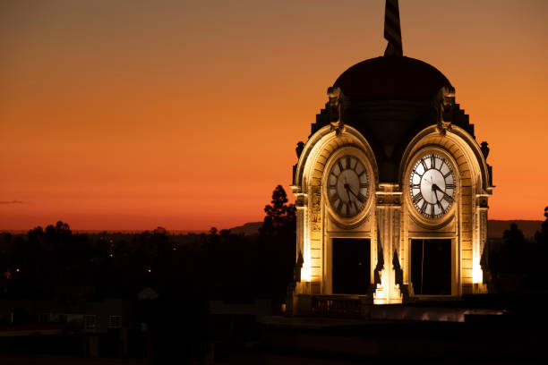 Sunset view of the historic clock tower in downtown Santa Ana, California, USA.