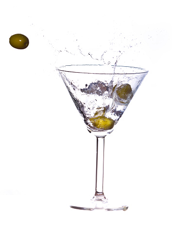 Olives in a martini Splash on white background