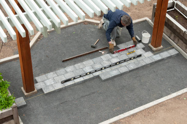 Installing patio cement paving bricks stock photo