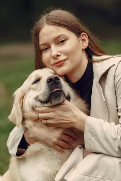 istock Woman walks in autumn forest with a dog 1293536704