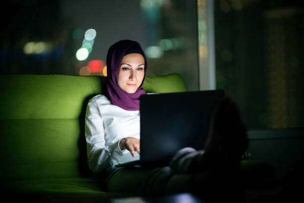 istock Muslim woman using laptop at night 1293536821
