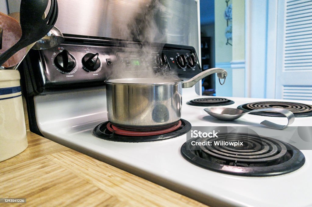 Steam Swirling Up From Pot Of Boiling Water On Red Hot Electric Stove  Burner Stock Photo - Download Image Now - iStock