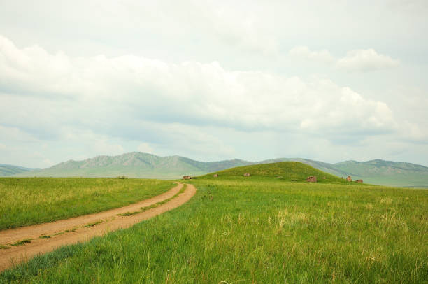 istock A field road going through the steppe turns off at an ancient burial mound. 1293545183