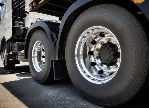 Large chromed truck wheel and big tires. Semi truck transport industry. Road freight.