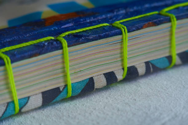 istock Closeup shot home bound notebook with recycled paper sheets. green woven thread 1293548983