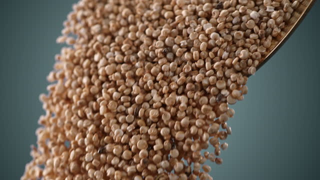 quinoa seeds pouring from a scoop