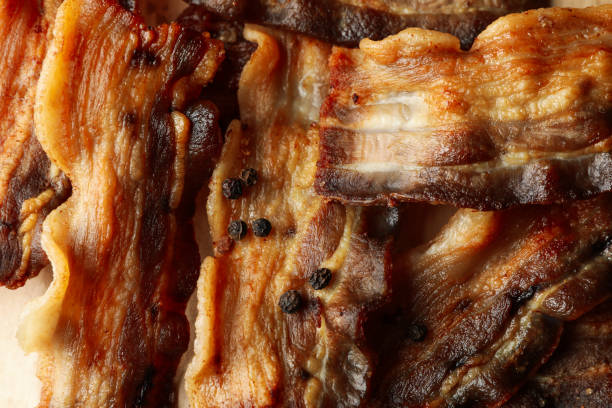 istock Tasty fried bacon with pepper, close up 1293559326