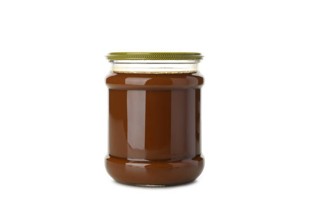 istock Glass jar with caramel condensed milk isolated on white background 1293560121