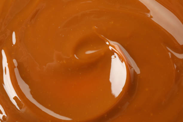 istock Caramel condensed milk on whole background, close up 1293560679