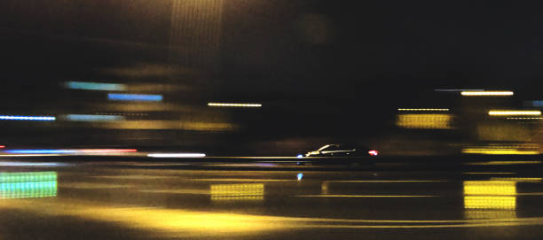 istock A BLACK CAR MOVES ON TRAFFIC 1293562690