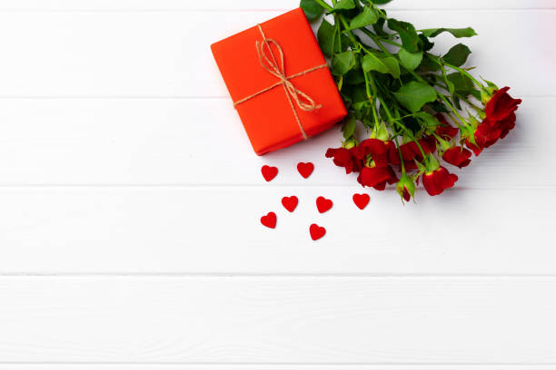istock Bouquet of roses and gift box top view 1293563674