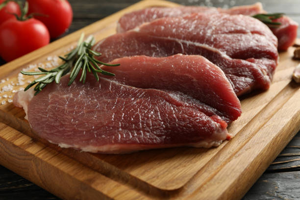istock Board with fresh raw steak meat on wooden background 1293563685