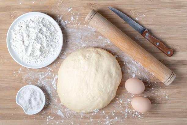 istock Top view of dough and baking ingredients on wooden table 1293564678