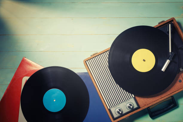 istock Vintage turntable with a vinyl records on rustic wooden table 1293565397