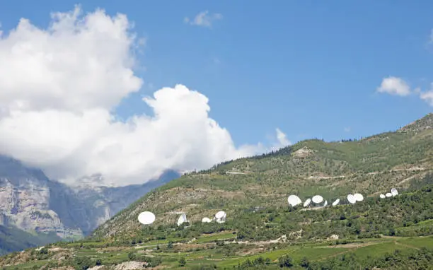 Radiotelescopes in the mountains, blue sky with clouds