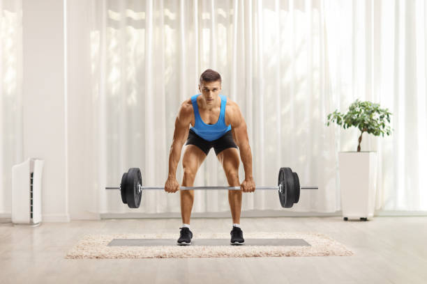 istock Strong young man in sportswear doing weightlifting 1293571088