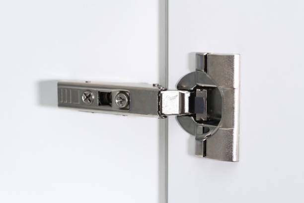 istock Man adjusts hinges soft closing on cabinet door. 1293572273