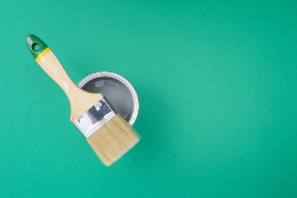 istock Open paint enamel cans on green turquoise palette samples. 1293572313