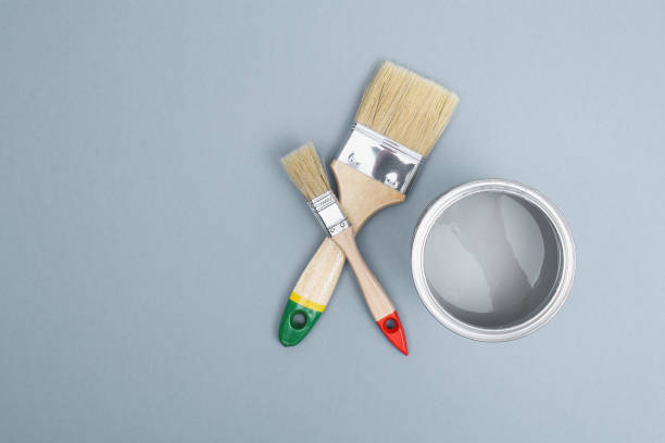 istock Open paint enamel cans on gray palette samples. 1293572320