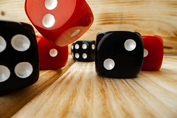 istock Red and black dice cubes on wooden background 1293574966
