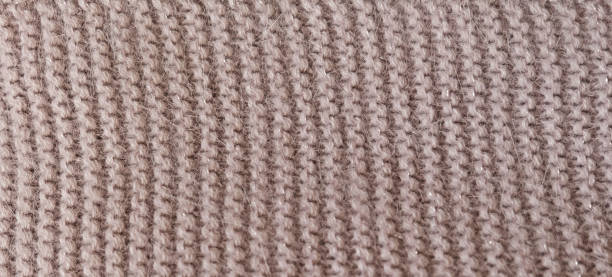 istock Gray knitted fabric texture. Product from wool. Handwork.  Qualitative gray fabric texture. Abstract background. Close up. 1293575373