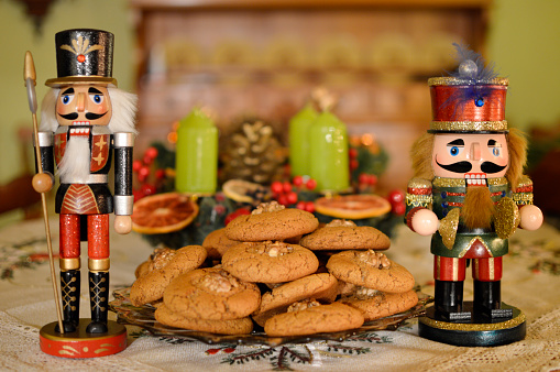 wooden Nutcracker toys an christmas cookies close up