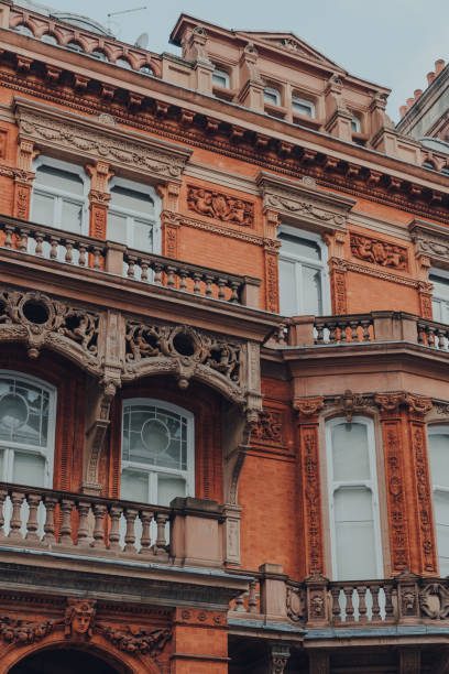 Traditional red brick apartment block in Mayfair, London, UK. Low angle view of traditional red brick apartment block with balconies in Mayfair, London, UK. Mayfair stock pictures, royalty-free photos & images