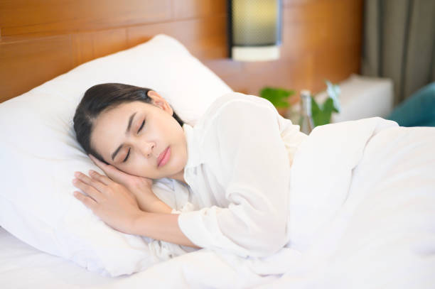 istock Young beautiful woman sleeping in her bed at home 1293579721