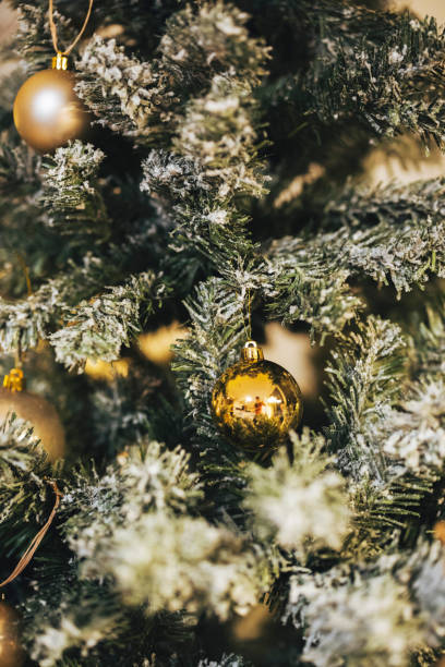 istock Golden ornament on Christmas tree reflecting light 1293579996
