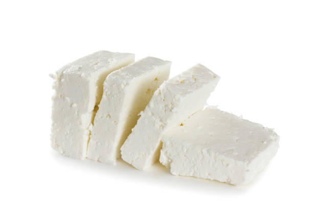 Sliced fresh white cheese Sliced fresh white cheese isolated on white background feta cheese block stock pictures, royalty-free photos & images