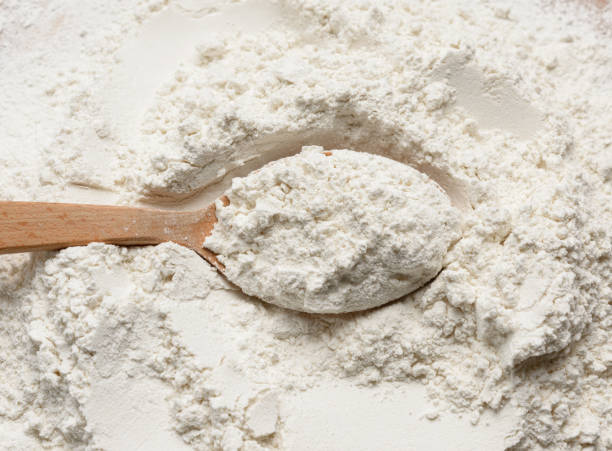 istock white wheat flour in a wooden spoon, top view 1293583839