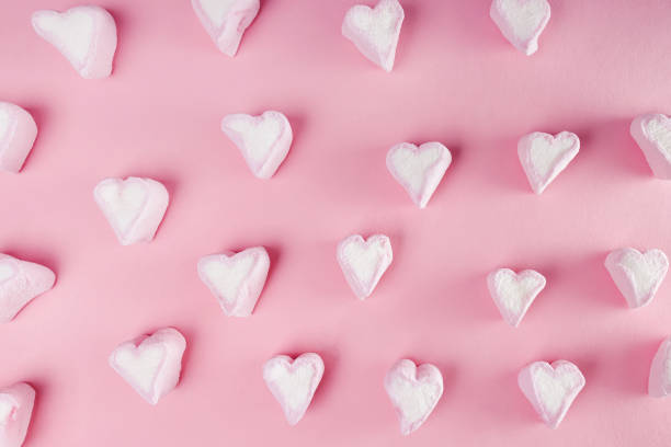 istock Heart shape marshmallow on pink background. 1293585976