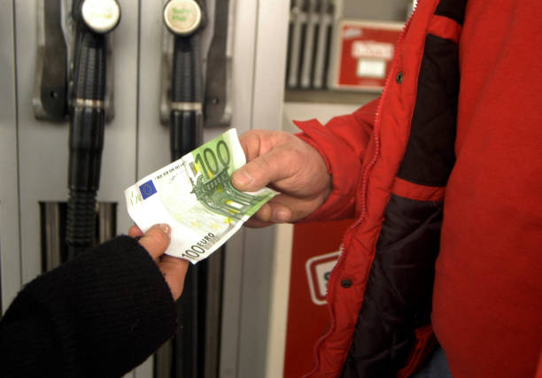 fuel costs at the gas station money exchange at the petrol station, hundred euro banknote, fuel costs cash in transit vehicle stock pictures, royalty-free photos & images