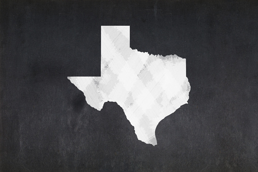 Blackboard with a the map of the State of Texas (USA) drawn in the middle.