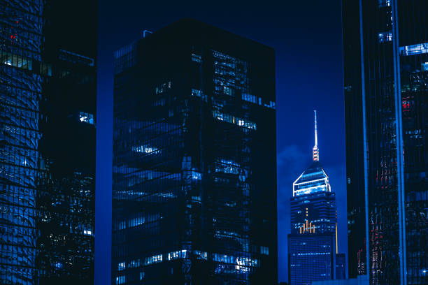 istock Directly below of modern buildings at night 1293587311