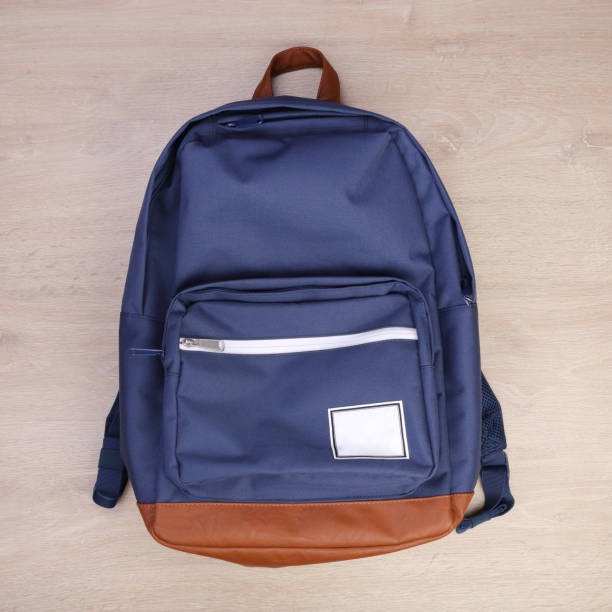 istock Blue navy backpack on wooden background 1293588297