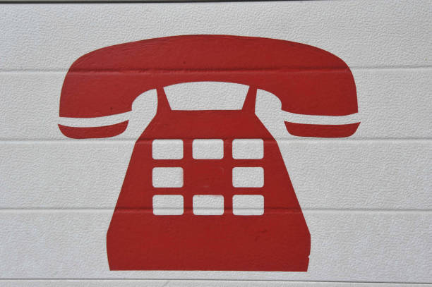 a red landline telephone symbol with receiver, on white background
