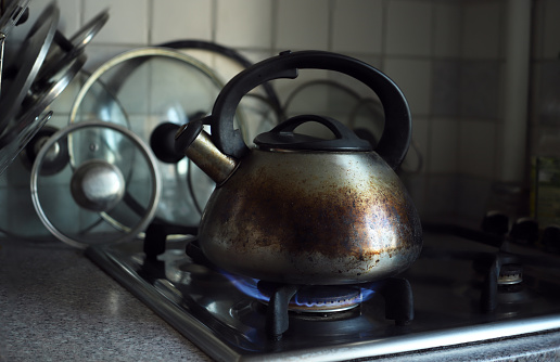 burnt kettle on the gas stove in the kitchen