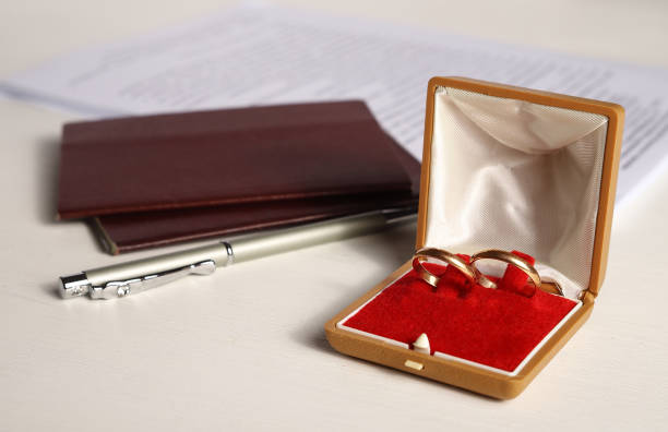 istock wedding gold rings in a box with two passports and a pen with documents. 1293590554