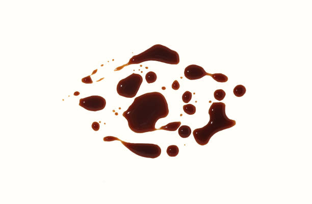 istock drops of black sauce on a white background. Abstract texture. 1293590559